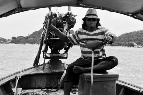 Man on long tail boat for a island tour