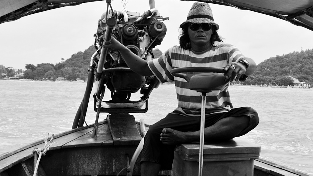 Man on long tail boat for a island tour