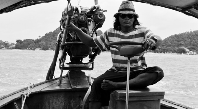 Man on long tail boat for a island tour