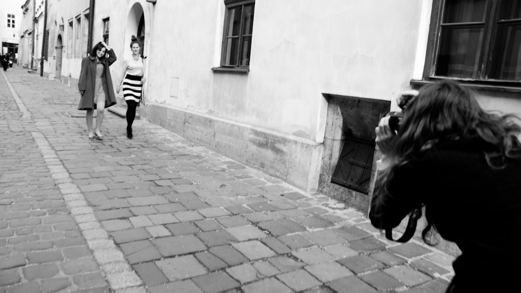 Photographer with models in action on Kanonicza street in Krakow