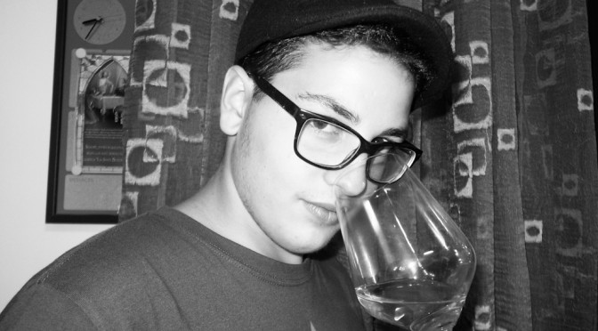 PUPUCCIO SNIFFS A GLASS OF WINE FOR US