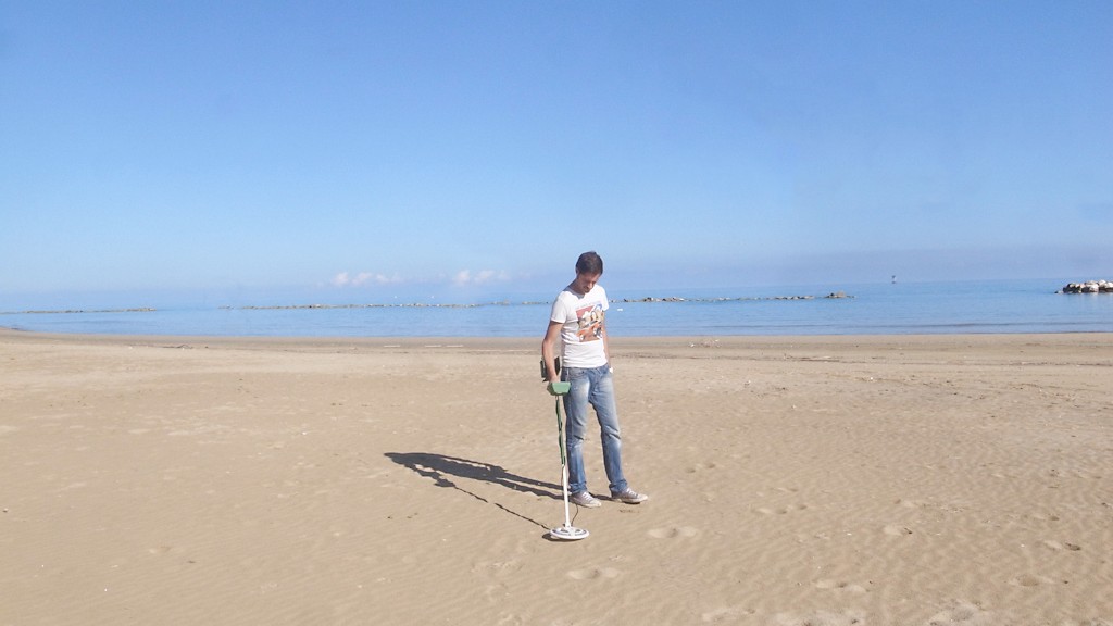 MAN WITH HIS METAL DETECTOR