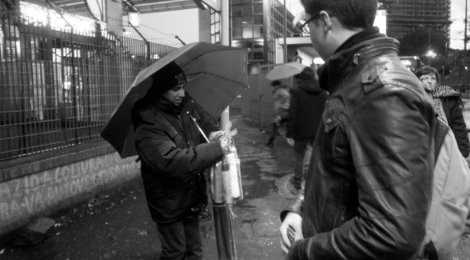 DAVIDE POMPEO IS BUYING AN UMBRELLA AT TIBURTINA BUS STATION IN ROME