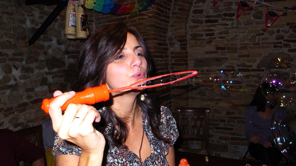 Francesca makes soap bubbles with stick